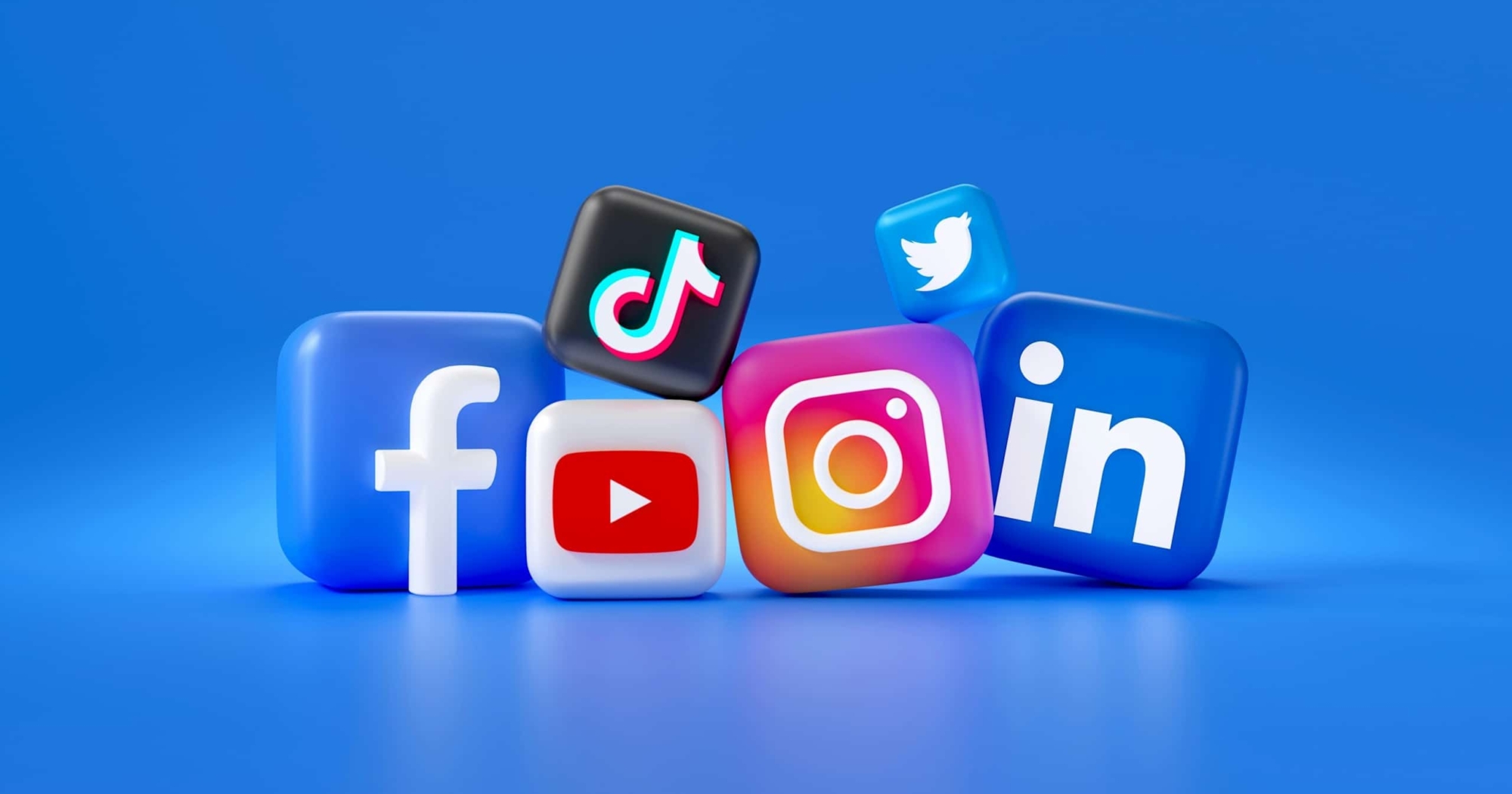 3D icons of popular social media platforms—including Facebook, YouTube, TikTok, Instagram, Twitter, and LinkedIn—stacked together on a blue background, perfect for addressing enrollment campaign questions.
